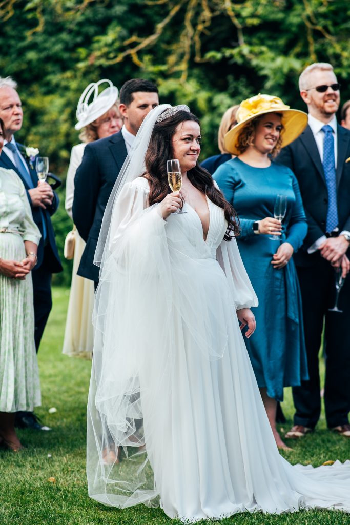 bride raises glass during speeches