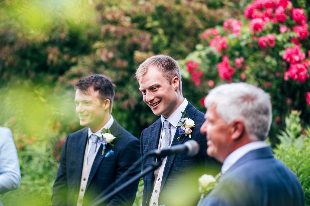 groom smiles at father of bride speech