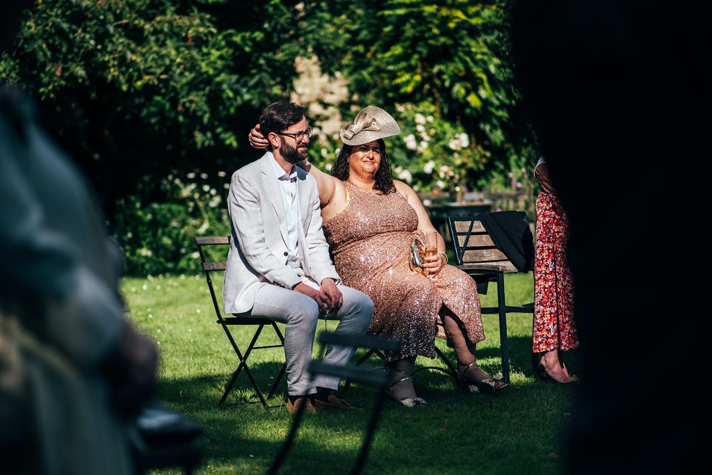 wedding guest tickles husbands neck during speeches