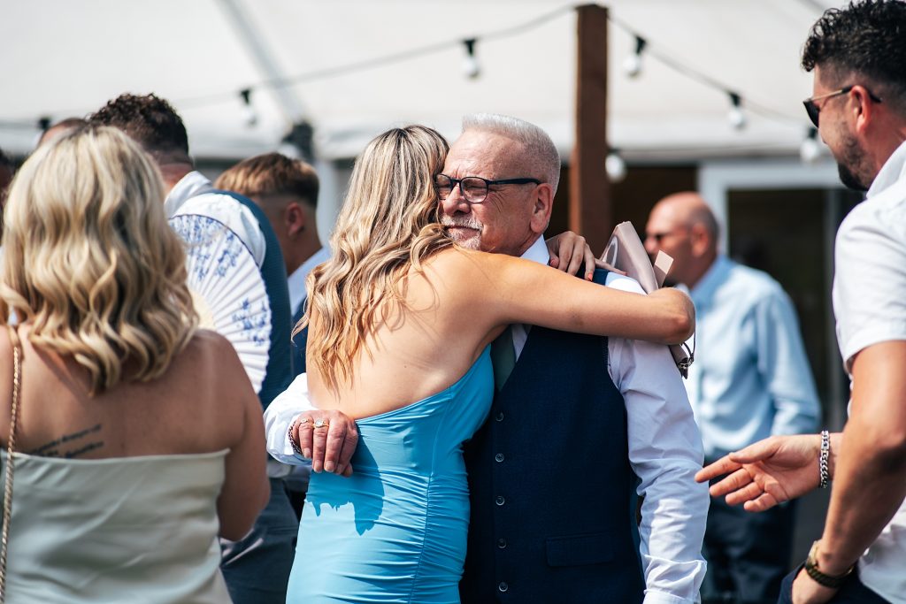 wedding guests hug
