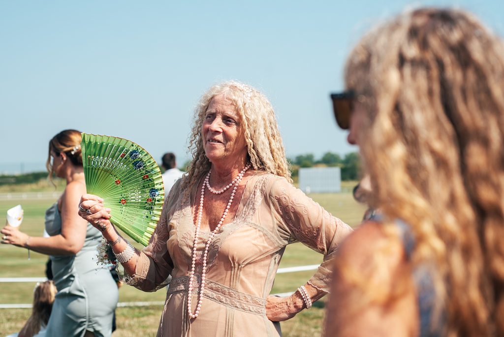 wedding guest fans herself