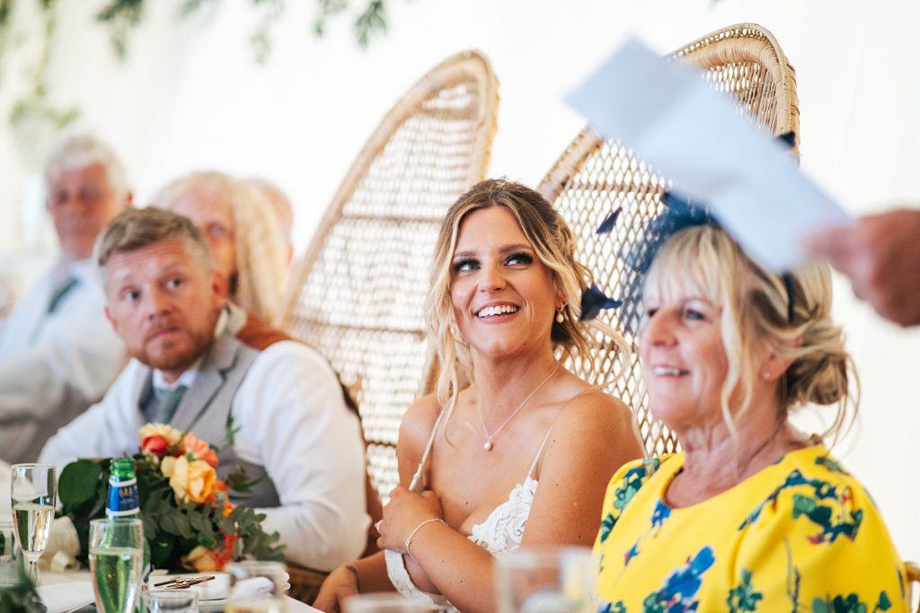 bride smiles during speeches
