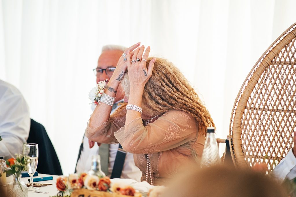 guest hides her face during speech