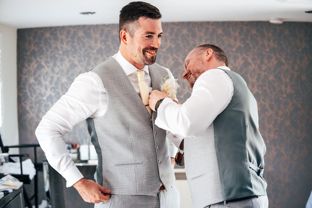 groom has button hole put on