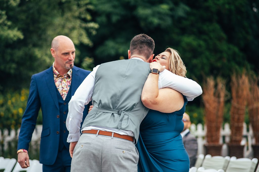 groom hugs guest
