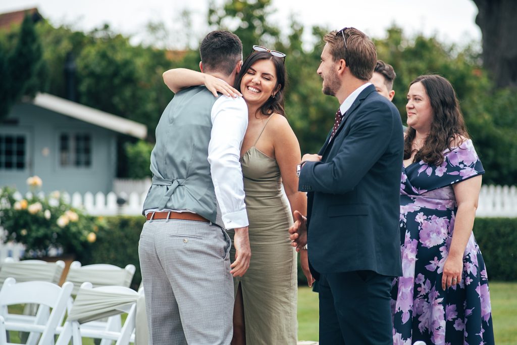 groom hugs guest