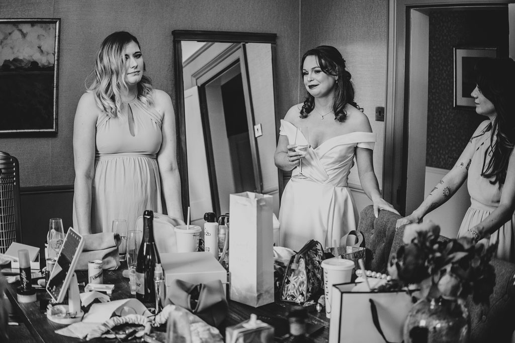 bride and bridesmaids wait for ceremony and drink champagne