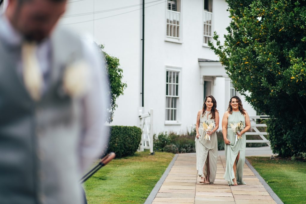 bridesmaids walk down aisle