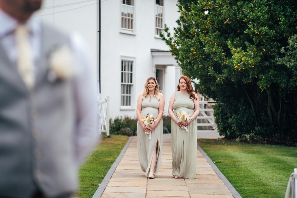 bridesmaids walk down aisle