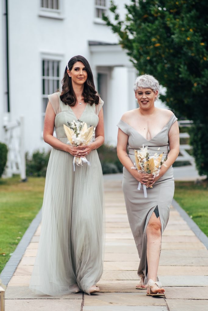 bridesmaids walk down aisle