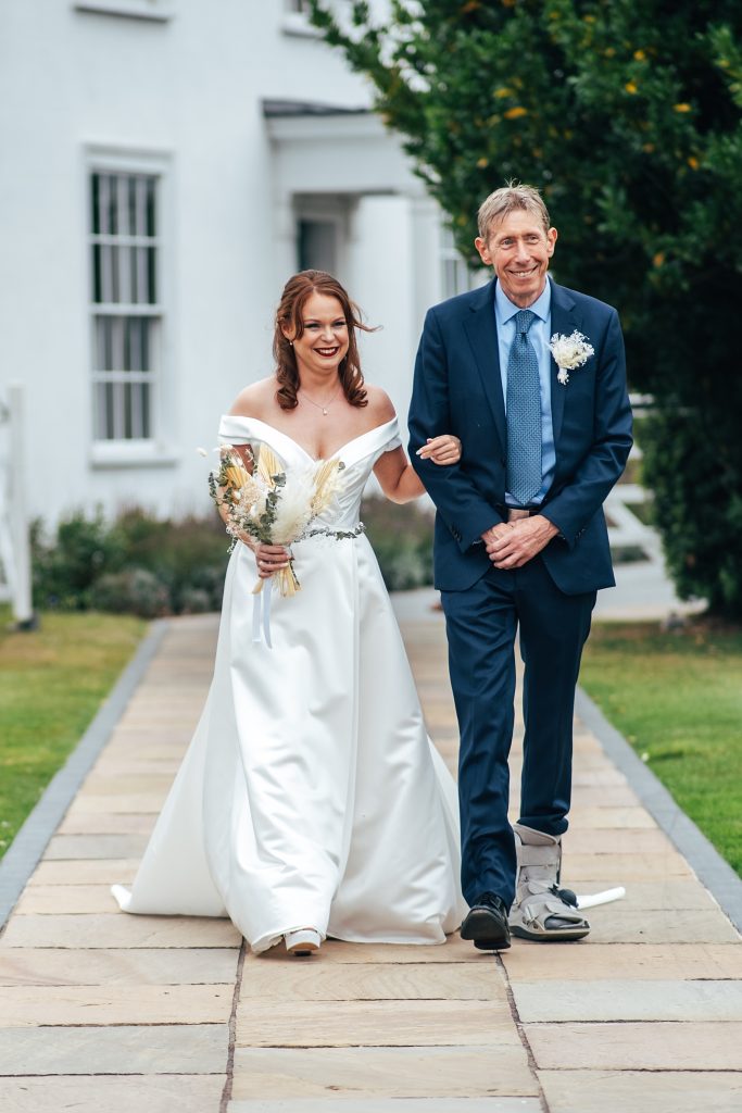 bride and dad walk down aisle