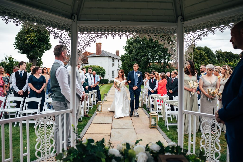 bride and dad walk down aisle