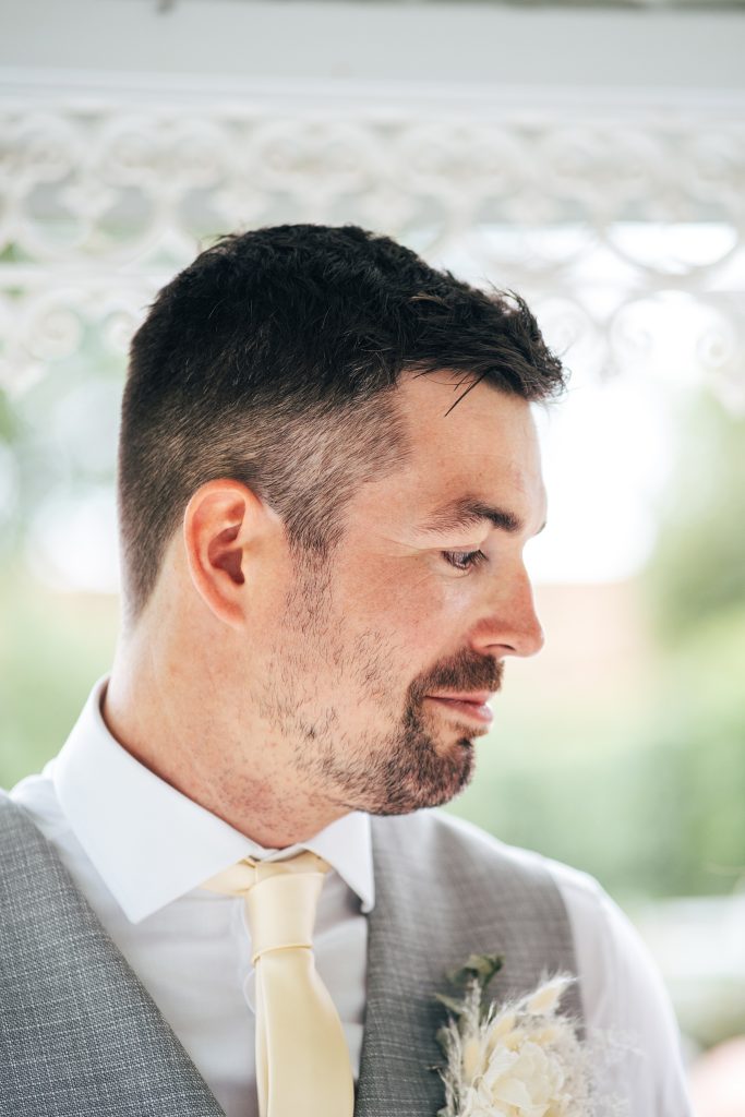close up of groom during ceremony