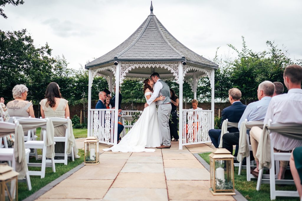 bride and groom kiss after ceremony