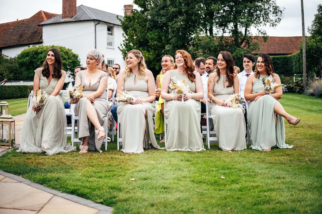 laughing bridesmaids during ceremony