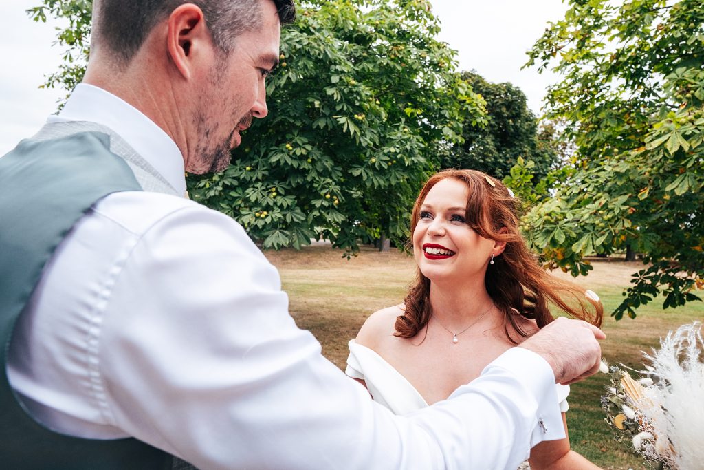 groom brushes confetti from brides hair