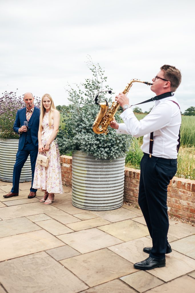 guests watch saxophonist