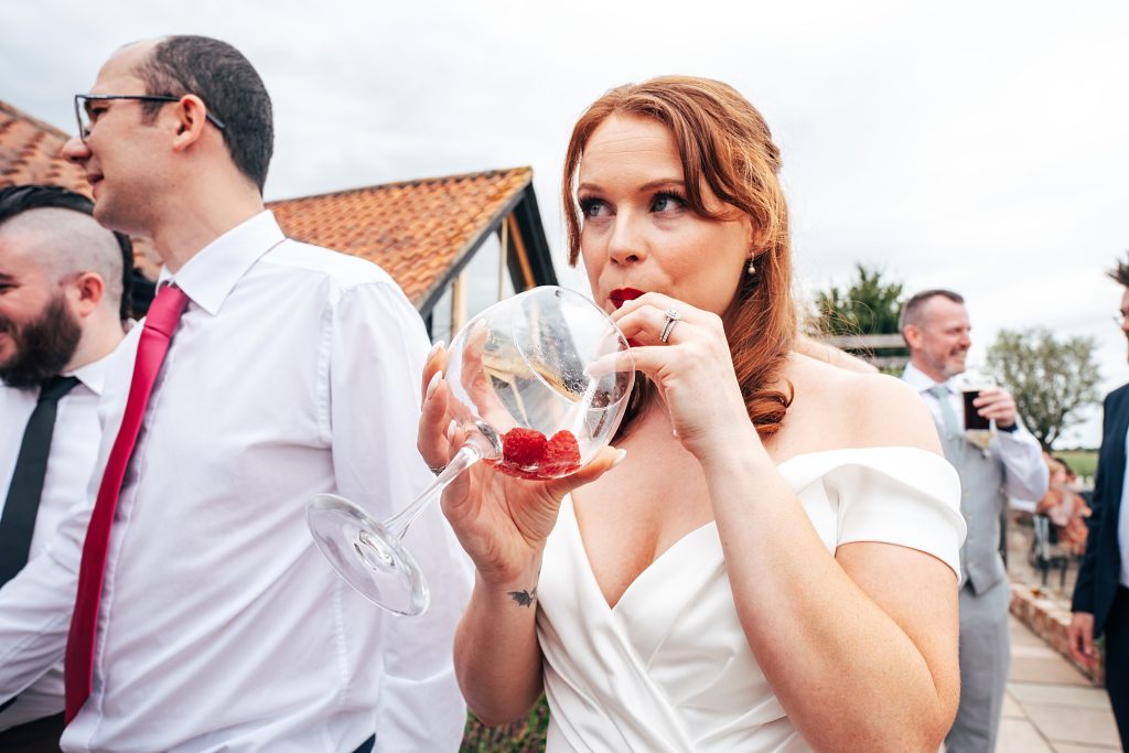 bride drinks from a huge gin glass