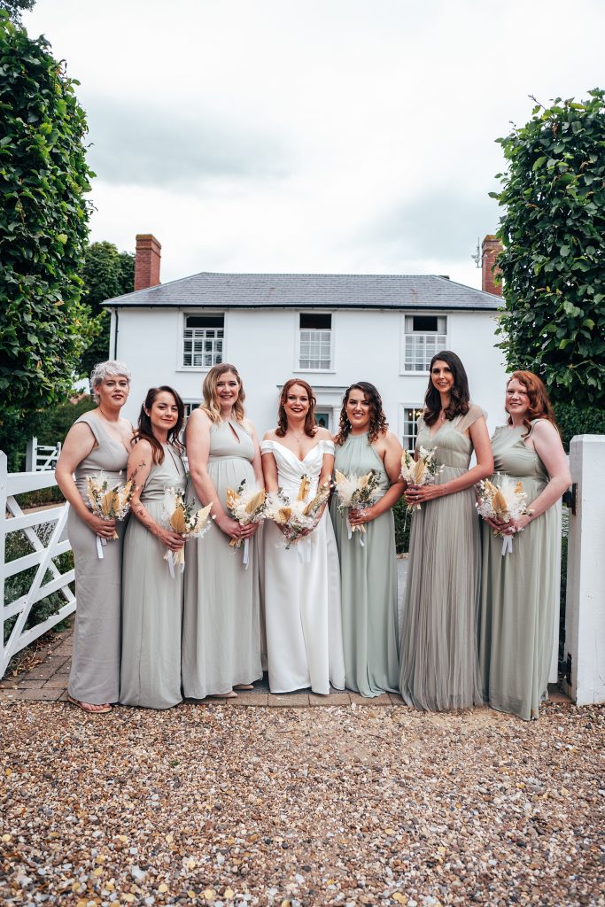 bride and bridesmaids in gateway in front of white house