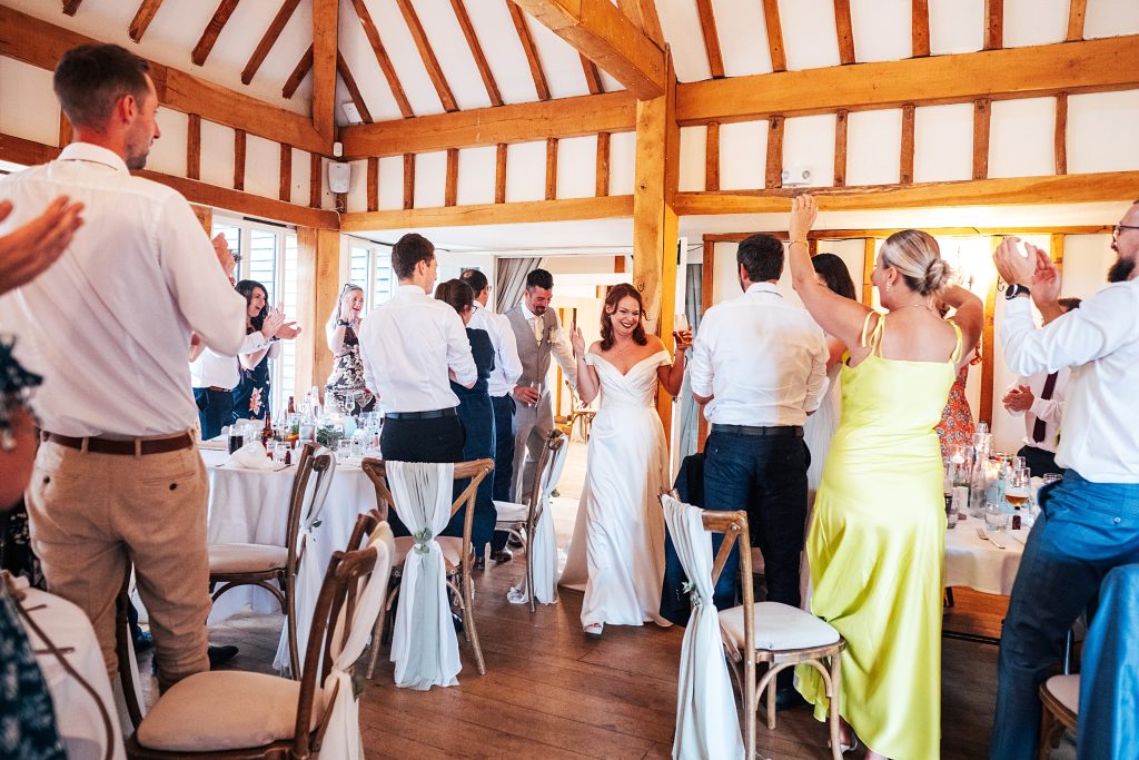 guests clap entrance of bride and groom