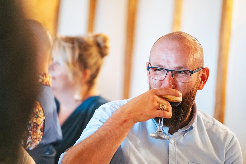 laughing guest sips espresso martini