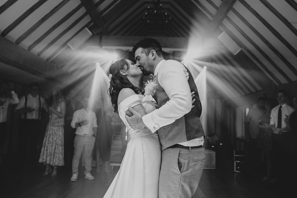 bride and groom kiss on dance floor