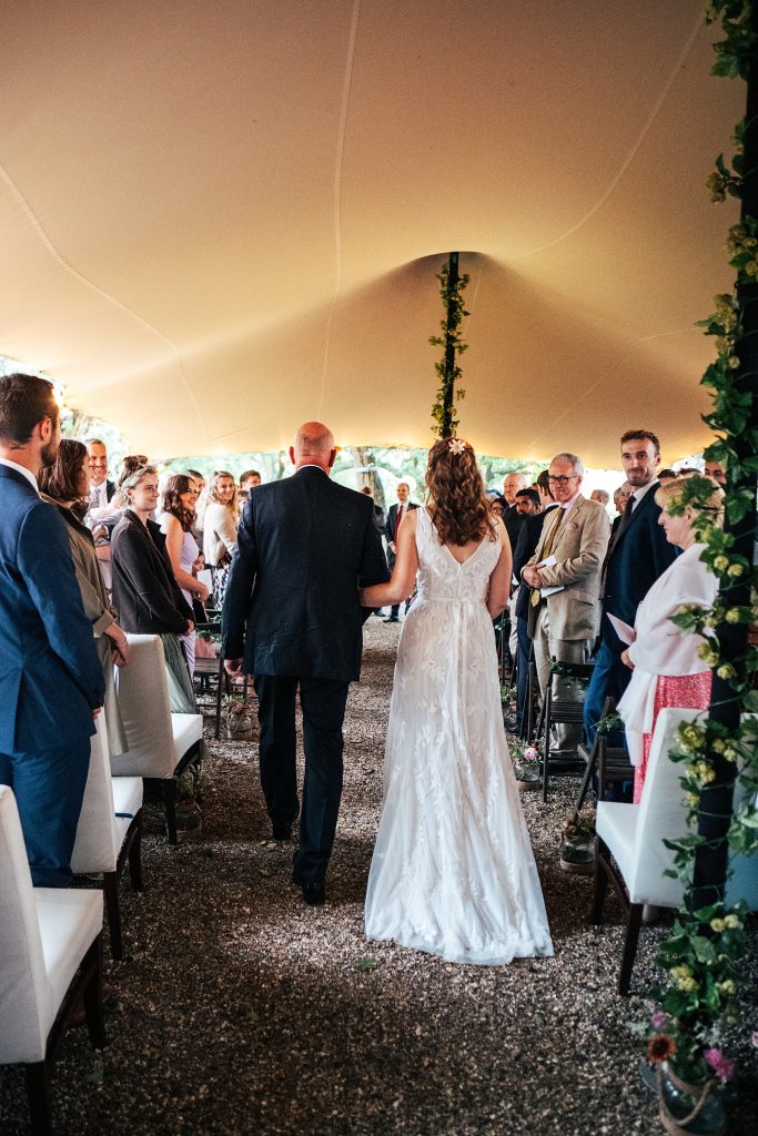 bride walks down aisle with dad
