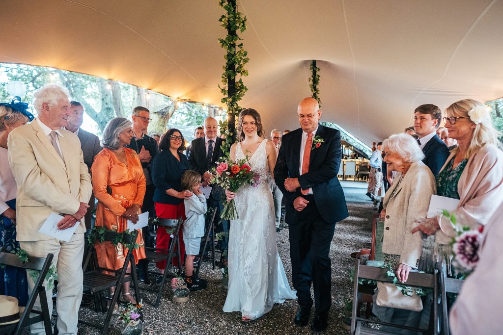 bride and her dad walk down aisle