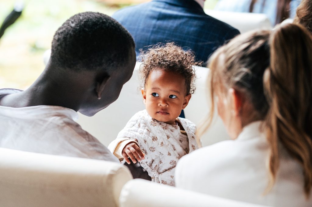 baby girl looks at her dad during ceremony