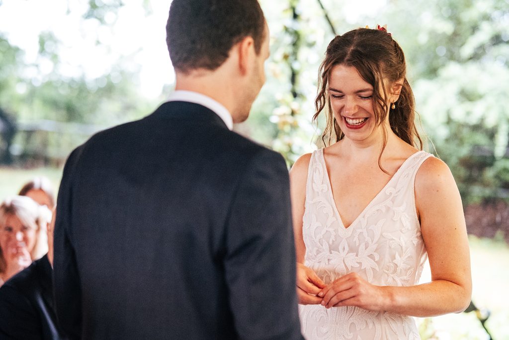 bride laughs during wedding ceremony