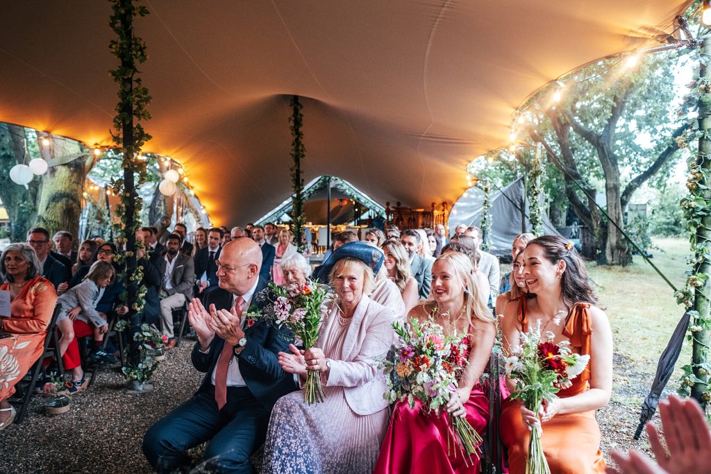 wedding guests clap after ceremony