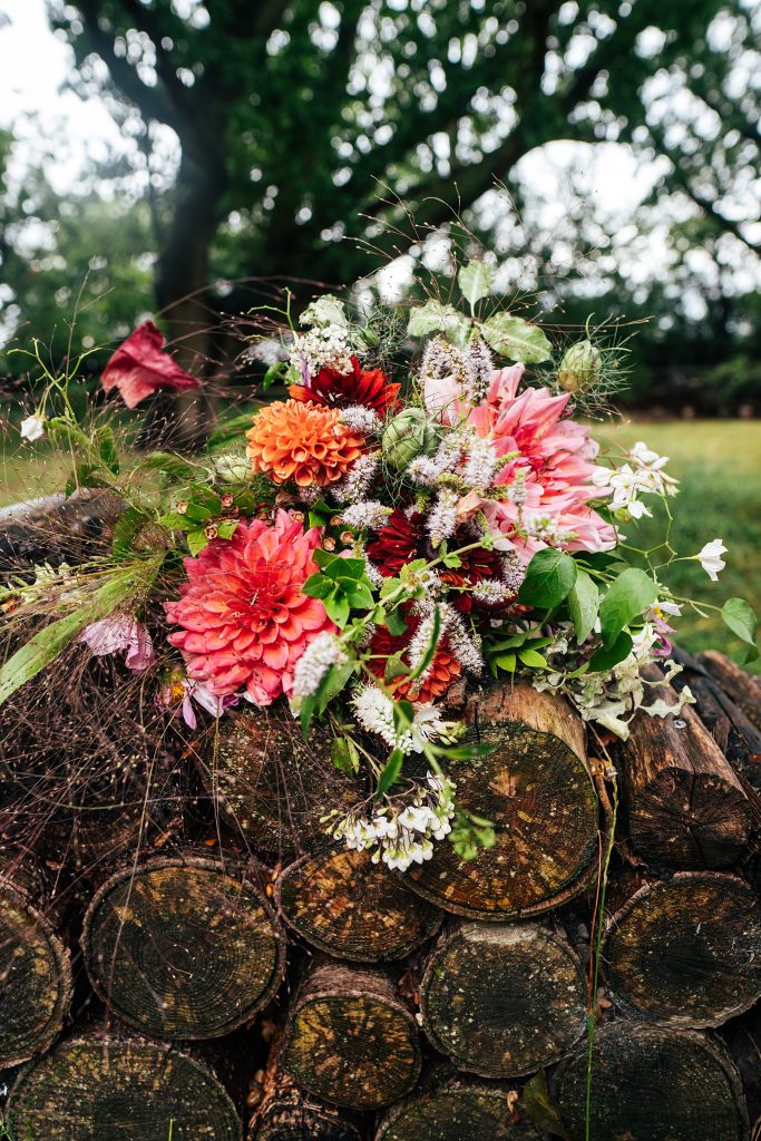 brides wild flower bouquet on log pile