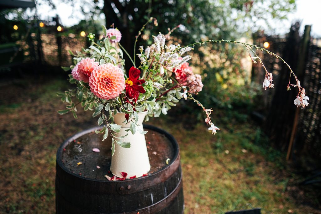 wild flower bouquet in jug on a barrel