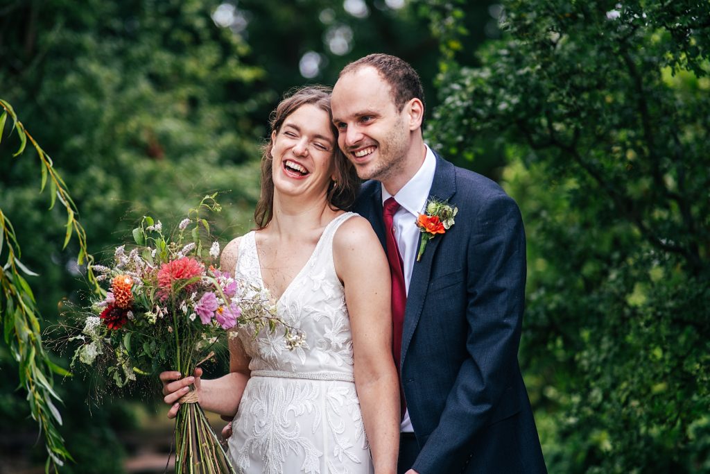 laughing bride and groom in garden