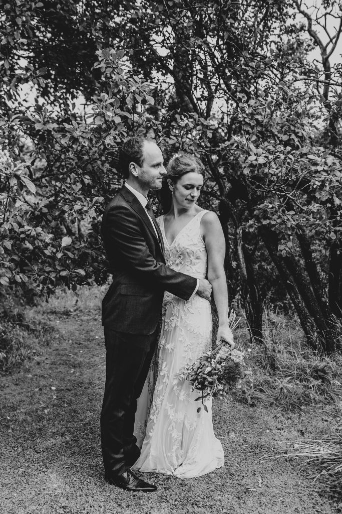 bride and groom in orchard