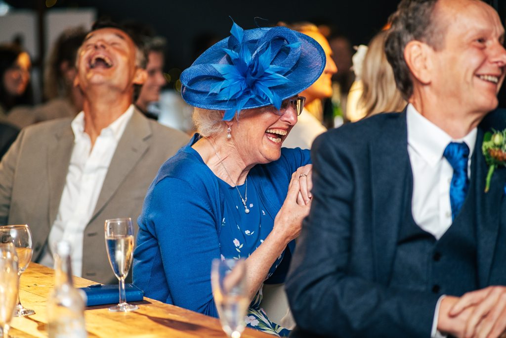 wedding guests laugh at speeches