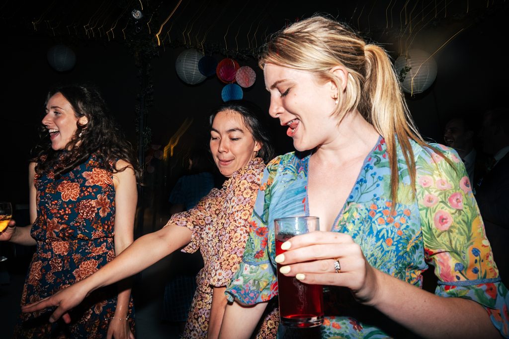 three wedding guests on dance floor