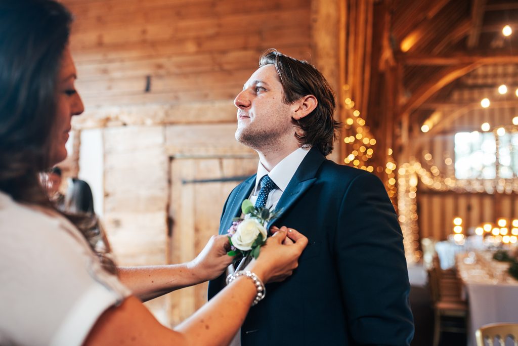 groom has button hold put on
