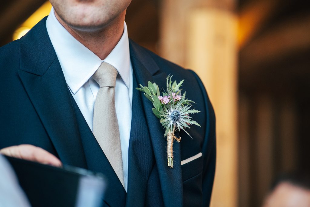 close up of grooms button hole