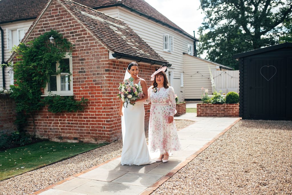 mum waits with her daughter to walk her down aisle