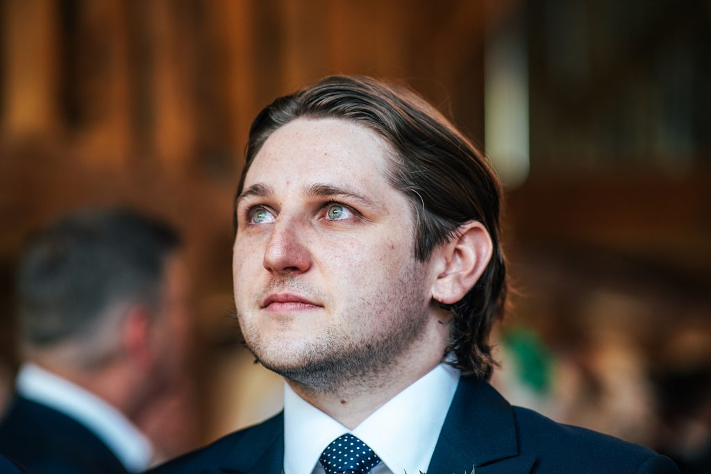 emotional groom, tears welling in his eyes as bride walks down aisle