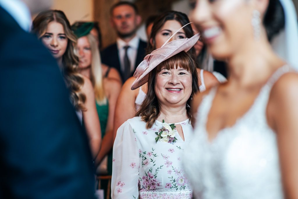 brides mum smiles during ceremony