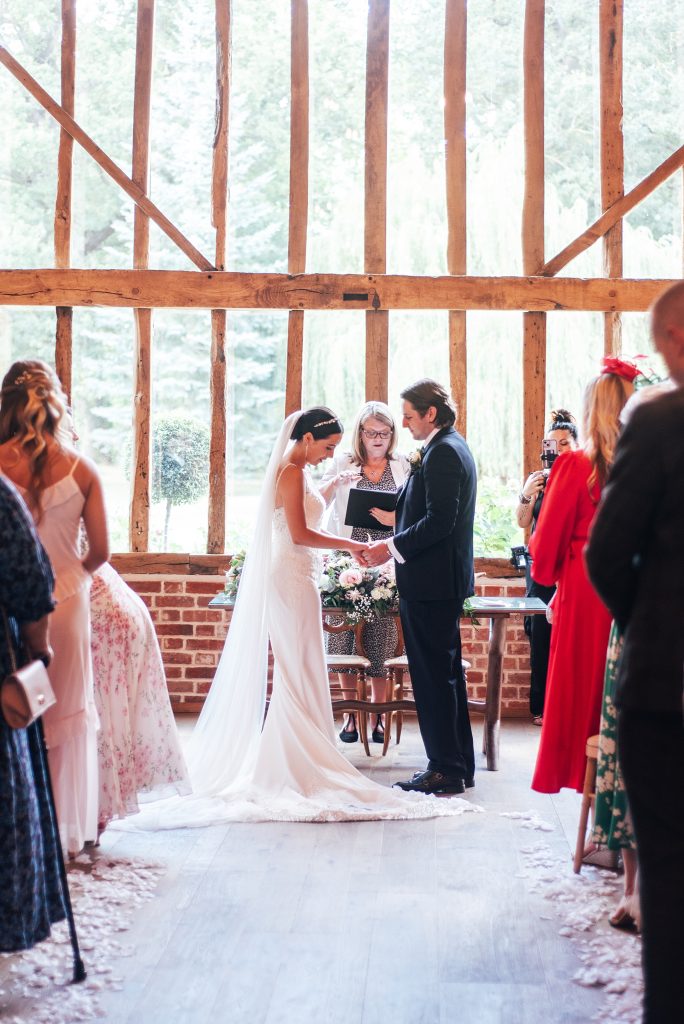 rear view of bride and groom talking vows