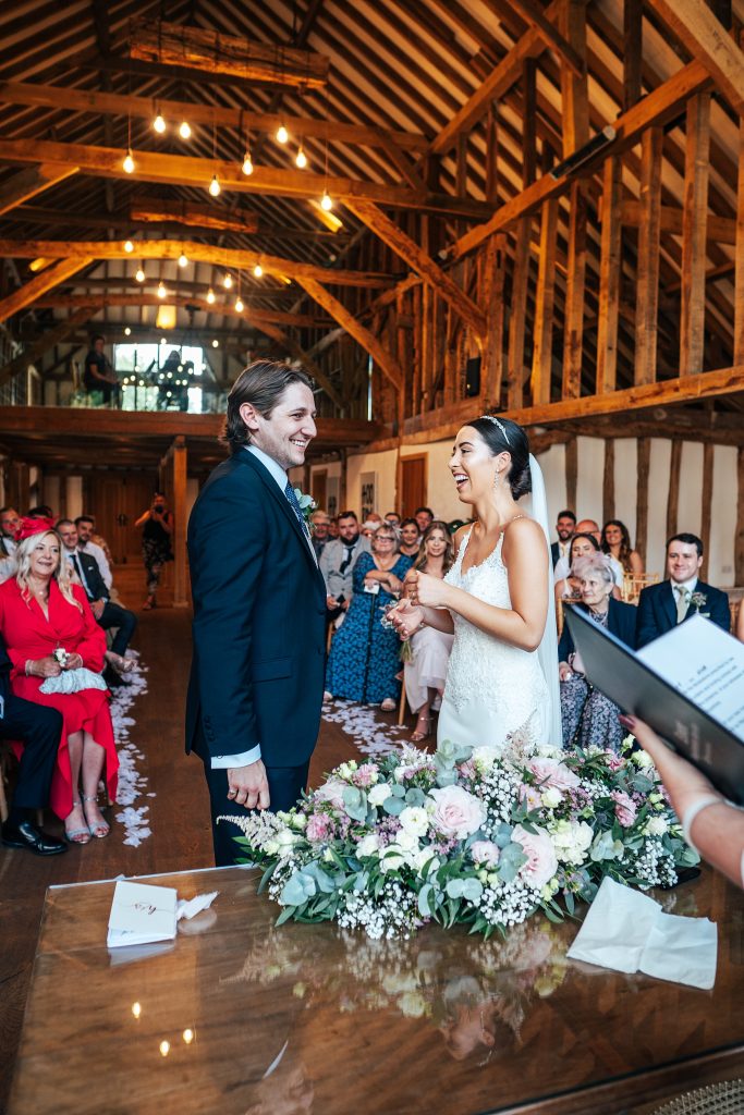 bride and groom laugh as they exchange rings
