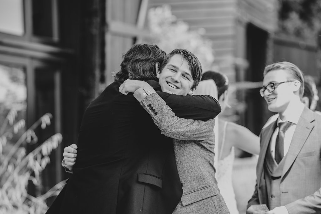 guest hugs groom