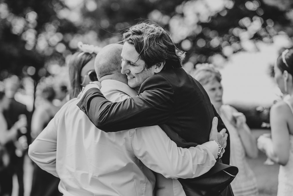 guest hugs groom