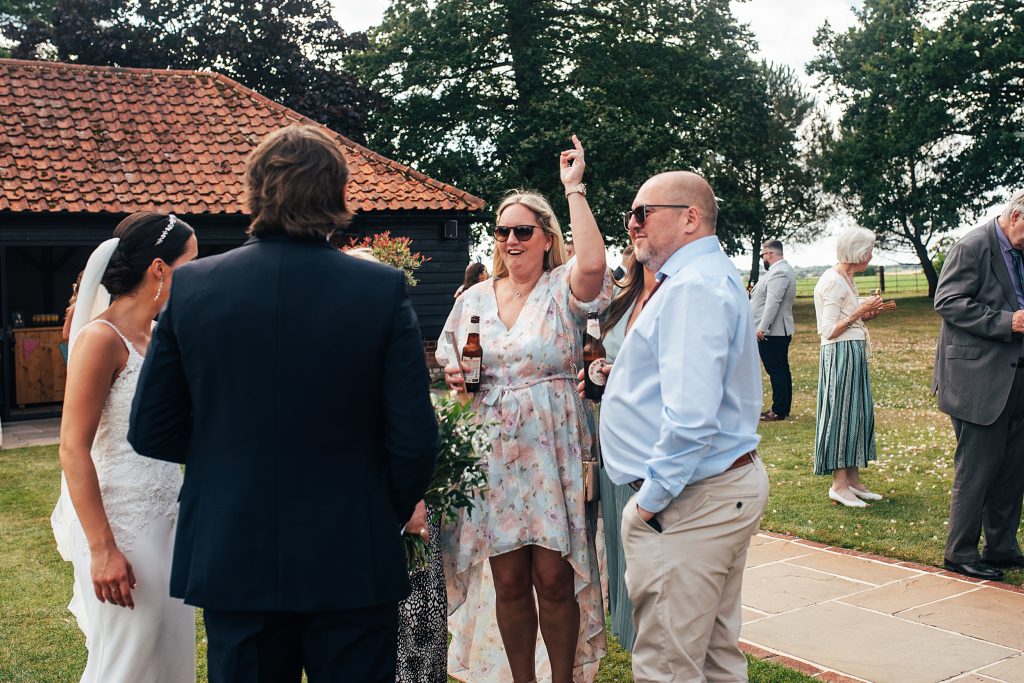 wedding guests mingle on lawn