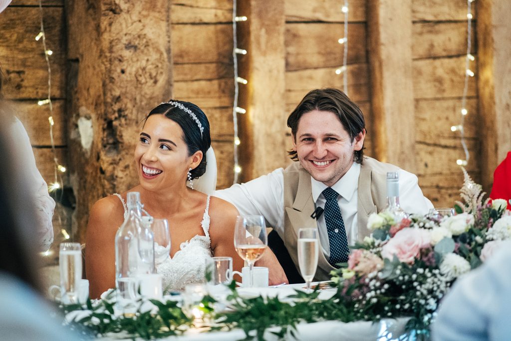 bride and groom laugh at speeches