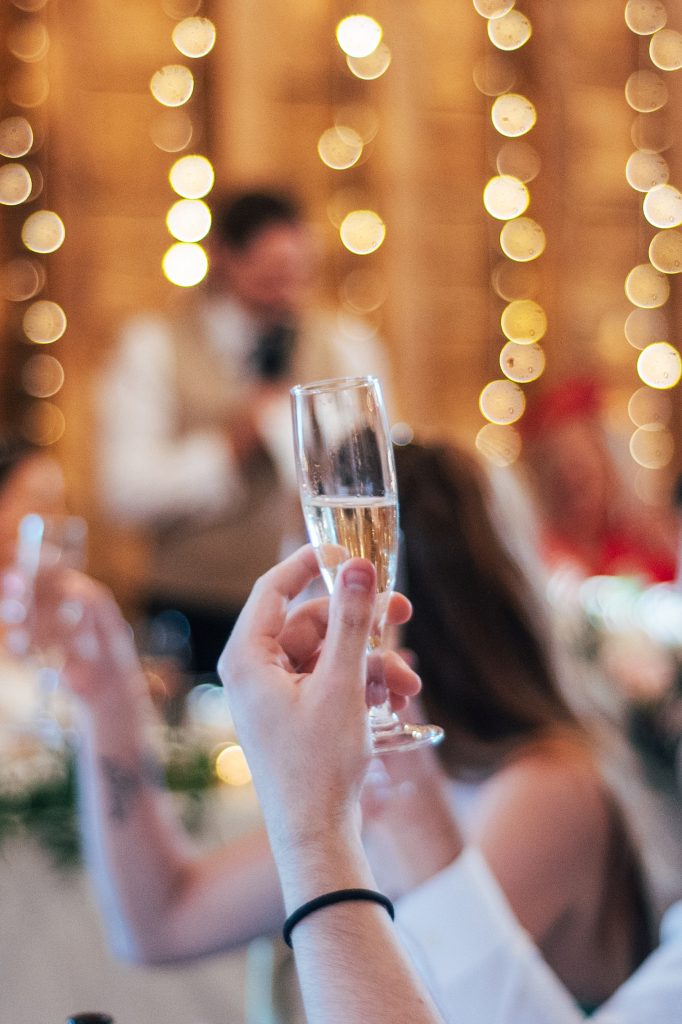 close up of guest holding champagne glass