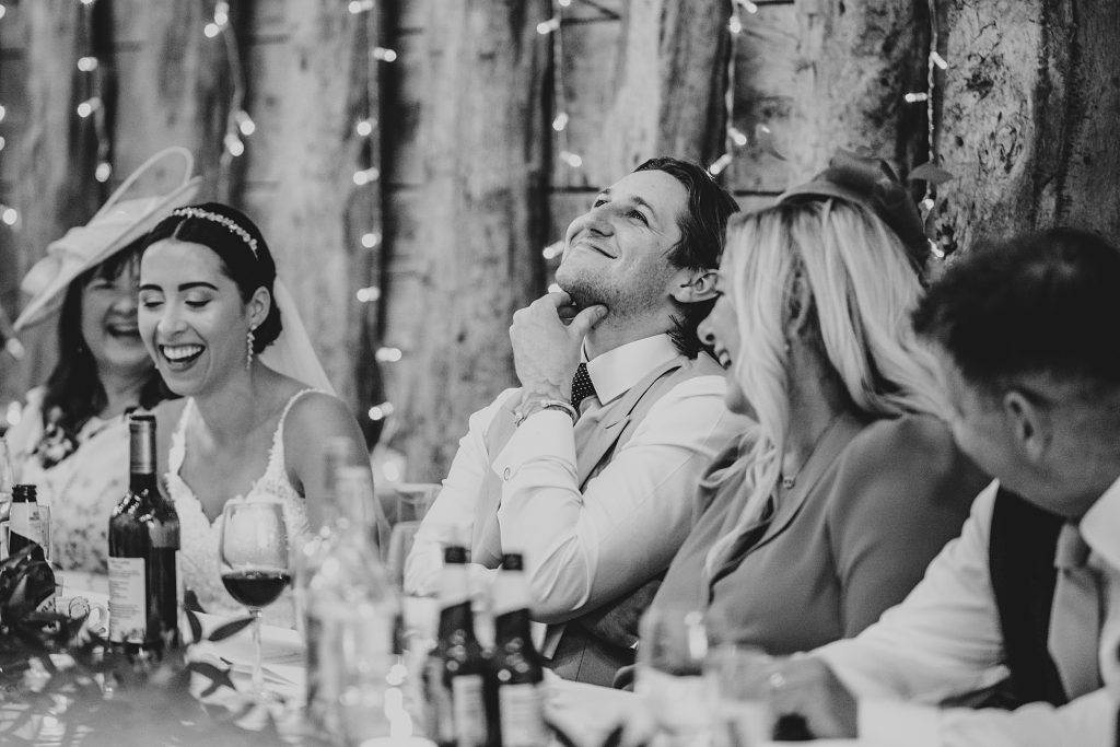 groom looks embarrassed during speeches